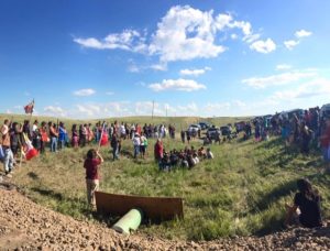 Wide circle of water protectors at one end of Dakota Pipeline